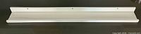Full view of white picture ledge shelf front and top