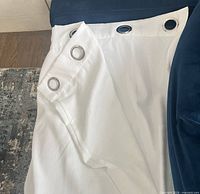 Close-up of top edge showing silver grommets and fabric texture