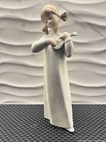 Front view of Lladro porcelain girl musician figurine