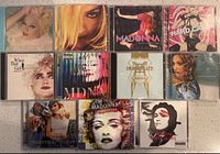 Group shot of all 11 Madonna CDs with visible cover art