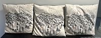 Front view showing three matching pillows with winter forest design