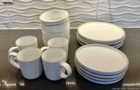 Full 16-piece Mikasa Ella set arranged on countertop