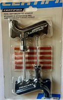 Front of sealed package showing tools and plugs