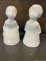 Front view of both white ceramic angel figurines