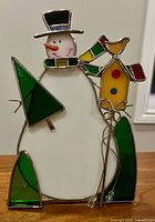 Front view of stained glass snowman tealight holder showing all colored glass sections
