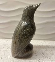 Left profile of soapstone bird figurine showing full form and color