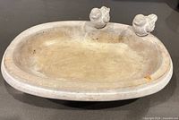 Top view of concrete tabletop bird bath with birds mounted