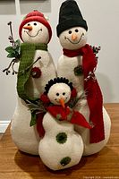 Front view showing all three snowmen with accessories