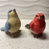 Front view of both resin bird figurines