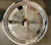 Round stainless tray top view showing concentric design and overall wear