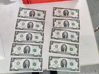 Fronts of ten sequential $2 bills laid out