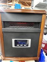 Front view showing grille, Amazon Basics logo, digital display