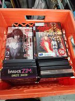 Crate overview with Basilisk, Tekken, Invader Zim box and stack of other DVDs