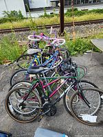 Front view showing six bicycles lined together on pavement