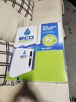 Box showing EcoSmart ECO 36 electric tankless water heater branding and features