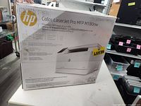 Front of HP Color LaserJet Pro MFP M180nw box showing printer image and specs