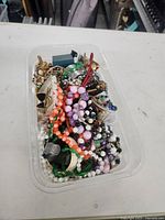 Top view of tote showing mixed beaded necklaces, bracelets and jewelry pieces