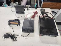 All components laid out including Kenwood transceiver body, control head, microphone, Astron power supply, dash device, Brookstone monitor