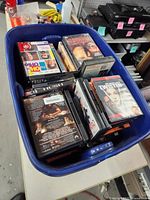 Top view of blue tote filled with assorted DVD movie cases