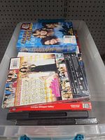 Top view of tote showing Charlie’s Angels box set, assorted DVDs beneath