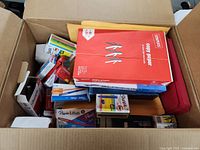 Overview of box showing Staples copy paper, envelopes, writing supplies
