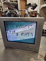 Front view of Orion 21-inch CRT TV displaying movie title via VHS playback