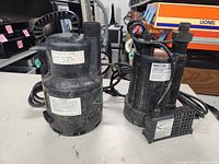 Both pumps side by side on table showing overall condition and cords