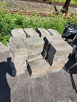 Stack of rectangular concrete pavers showing rough and smooth faces