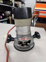Front view of Porter-Cable router showing base, knobs, cord