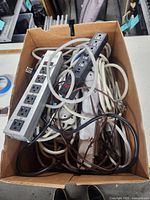 Top view of box showing multiple power strips with cords