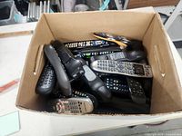 Top view showing multiple remote controls inside box