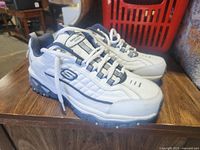 Side view of both sneakers showing upper, outsole, and laces