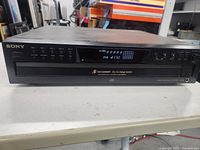 Front view showing Sony branding, display, 5-disc tray and controls