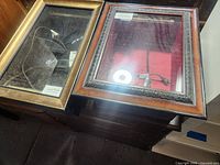 Both display cases closed, showing frame finishes and glass fronts