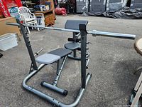 Full view of adjustable weight bench with barbell on rack