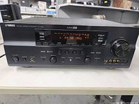 Front view of Yamaha receiver showing controls and display
