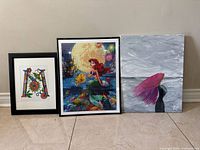Group shot of three framed artworks