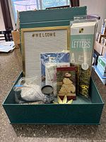 Open storage box showing letter board, letters pack, diamond-painting kits and accessories