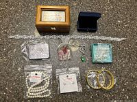 All items laid out: headband, boxes, bangles, pearl items, tin, charm, pouches