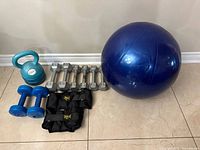 Group shot of kettlebell, dumbbells, ankle weights, exercise ball