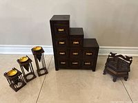 All items together: spice box, 9-drawer chest, three candle holders