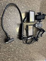 Overview of two GPS units, phone mounts, gooseneck mount and cables