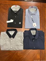 Overview of four folded dress shirts
