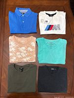 All six folded shirts displayed on table