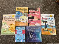 Front covers of six of the seven books laid out on countertop