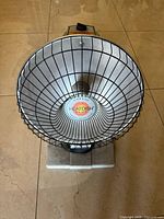 Front view showing parabolic dish, grill, logo, base