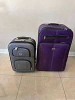 Front view of both suitcases showing colors, sizes, front pockets