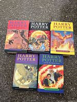 Image of five Harry Potter hardcover books arranged on surface