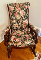 Front view of rocking chair showing full upholstery and wood frame