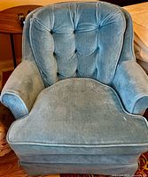 Front view of blue velour swivel rocker chair